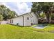 Exterior view of home's backyard featuring a rectangular pool and well-maintained lawn at 1891 Bryan Ave, Winter Park, FL 32789