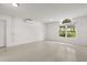Bright bonus room features neutral decor and a large arched window letting in natural light at 1891 Bryan Ave, Winter Park, FL 32789