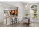 Bright dining area adjoining a kitchen with an island and featuring a modern table and chairs with a view at 1891 Bryan Ave, Winter Park, FL 32789