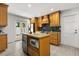 Well-appointed kitchen featuring custom wood cabinetry, granite counters, stainless steel appliances, and an island at 1891 Bryan Ave, Winter Park, FL 32789