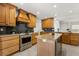 Spacious kitchen with granite countertops, stainless steel appliances, custom wood cabinetry, and a kitchen island at 1891 Bryan Ave, Winter Park, FL 32789