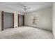 Spacious bedroom featuring a ceiling fan, large window, and double closets at 19 Hemlock Terrace Way, Ocala, FL 34472
