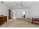 A bare bedroom with multiple doorways and neutral-colored carpet at 19 Hemlock Terrace Way, Ocala, FL 34472