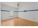 A bare bedroom features light hardwood floors and a ceiling fan at 19 Hemlock Terrace Way, Ocala, FL 34472