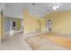 Bright living room with tile floors and archway to kitchen, offering a seamless transition at 19 Hemlock Terrace Way, Ocala, FL 34472