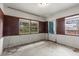 View of a bare living space with brick walls and windows looking out to outdoors at 19 Hemlock Terrace Way, Ocala, FL 34472