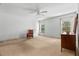 A spacious main bedroom featuring two windows, ceiling fan, and neutral carpeting at 19 Hemlock Terrace Way, Ocala, FL 34472