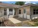 Exterior patio with a white door and ample sunlight, ready for outdoor seating at 19 Hemlock Terrace Way, Ocala, FL 34472