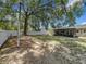 Spacious backyard with a covered patio, mature trees, and plenty of room for outdoor activities at 2109 Hartwell Ave, Sanford, FL 32771