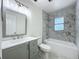 Stylish bathroom with modern vanity, updated fixtures, and shower with stylish marble-style tile at 2109 Hartwell Ave, Sanford, FL 32771