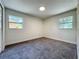 A cozy bedroom with two windows offers natural light and a comfortable space at 2109 Hartwell Ave, Sanford, FL 32771