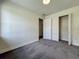 Cozy bedroom featuring neutral walls, carpeting, and a spacious closet for ample storage at 2109 Hartwell Ave, Sanford, FL 32771