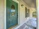 Close-up of the front door showing decorative glass, modern lighting, and tiled porch at 2109 Hartwell Ave, Sanford, FL 32771