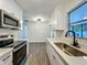 Well-lit kitchen with white cabinetry, stainless steel sink, and modern finishes at 2109 Hartwell Ave, Sanford, FL 32771