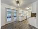 Bright kitchen with white cabinets, stainless steel appliances, and outdoor access at 2109 Hartwell Ave, Sanford, FL 32771