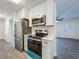 Updated kitchen with stainless steel appliances and modern white cabinetry at 2109 Hartwell Ave, Sanford, FL 32771