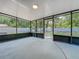 Enclosed patio area with full screening and concrete flooring overlooking a yard at 2109 Hartwell Ave, Sanford, FL 32771