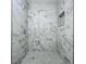 A shower with elegant marble-style tiles and a convenient shower niche at 2109 Hartwell Ave, Sanford, FL 32771