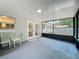 Spacious sunroom with screened windows providing the perfect spot for relaxation and enjoying the outdoors at 2109 Hartwell Ave, Sanford, FL 32771