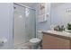 Bright bathroom featuring a walk-in shower with glass door and single sink vanity at 2222 Wyndham Palms Way, Kissimmee, FL 34747