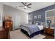Comfortable bedroom with a large bed, ceiling fan, and stylish decor at 2222 Wyndham Palms Way, Kissimmee, FL 34747