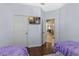 Bedroom view featuring hardwood floors, an ensuite bath and TV screen at 2222 Wyndham Palms Way, Kissimmee, FL 34747