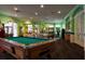 Spacious game room featuring a billiard table, arcade games, and ample seating, creating an entertainment hub for residents at 2222 Wyndham Palms Way, Kissimmee, FL 34747