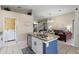 Open-concept kitchen with an island and direct access to the living area and laundry room at 2222 Wyndham Palms Way, Kissimmee, FL 34747
