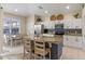 Spacious kitchen with a large island, stainless steel appliances, and a dining table with backyard view at 2222 Wyndham Palms Way, Kissimmee, FL 34747