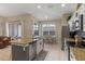 Well-equipped kitchen featuring stainless steel appliances and center island with sink and dishwasher at 2222 Wyndham Palms Way, Kissimmee, FL 34747