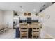 Bright kitchen features stainless appliances, a large island with seating and white cabinets at 2222 Wyndham Palms Way, Kissimmee, FL 34747