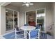 Covered lanai with dining table and chairs adjacent to the kitchen and living room at 2222 Wyndham Palms Way, Kissimmee, FL 34747