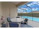 Covered lanai with a dining table and chairs, overlooking the screened-in pool area at 2222 Wyndham Palms Way, Kissimmee, FL 34747