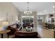 Bright living room featuring tile floors, comfortable seating, and a view of the pool at 2222 Wyndham Palms Way, Kissimmee, FL 34747