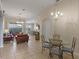 Open-concept living room with tile floors, comfortable seating, and abundant natural light at 2222 Wyndham Palms Way, Kissimmee, FL 34747