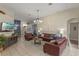 Inviting living room with tile flooring, stylish furnishings, and an open layout to the dining area at 2222 Wyndham Palms Way, Kissimmee, FL 34747