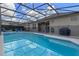 Enclosed pool area with a heated pool, privacy fence, and lounge chairs for relaxing at 2222 Wyndham Palms Way, Kissimmee, FL 34747