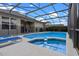 Inviting screened-in pool and spa area, perfect for relaxation and entertaining, with outdoor seating and lush landscaping at 2222 Wyndham Palms Way, Kissimmee, FL 34747