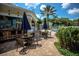 Outdoor pool area featuring patio seating, a bar, mature landscaping and sunny skies at 2222 Wyndham Palms Way, Kissimmee, FL 34747