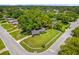 Aerial view of a well-maintained property with lush landscaping, a white picket fence, and a charming home at 224 Woodmere Blvd, Sanford, FL 32773