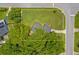 Expansive lot featuring lush green landscaping, bordered by mature trees and a charming fence at 224 Woodmere Blvd, Sanford, FL 32773