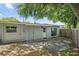 The backyard features a brick patio and mature trees offering plenty of shade at 224 Woodmere Blvd, Sanford, FL 32773