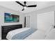 The bedroom includes a closet, wood flooring, ceiling fan, and a television mounted on the wall at 224 Woodmere Blvd, Sanford, FL 32773