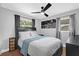 This bedroom includes a ceiling fan, wood flooring, and natural light from the large windows at 224 Woodmere Blvd, Sanford, FL 32773