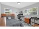 Well-lit bedroom with wood flooring, a comfortable bed, and windows providing natural light at 224 Woodmere Blvd, Sanford, FL 32773
