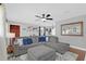 Cozy living room with a large sectional sofa, stylish decor, and modern ceiling fan at 224 Woodmere Blvd, Sanford, FL 32773