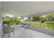 Relaxing screened porch with hammock, chair, and table with a view of the front yard at 224 Woodmere Blvd, Sanford, FL 32773