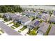 Aerial view of a residential neighborhood with modern homes and lush landscaping, some with solar panels at 2249 Litchfield Loop, Deland, FL 32720