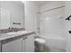 Bright bathroom featuring a shower-tub combo, a toilet, and a vanity with a sink and a granite-look countertop at 2249 Litchfield Loop, Deland, FL 32720