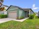 Charming one-story home featuring a two-car garage, manicured lawn, and inviting curb appeal at 2249 Litchfield Loop, Deland, FL 32720